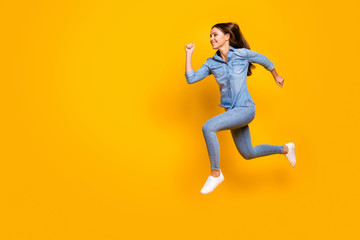 Poster - Full body profile photo of pretty funky lady jump high up rejoicing good mood rushing speed running final wear casual denim outfit white footwear isolated yellow color background