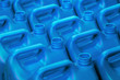 plastic canisters of light blue color in the warehouse, production, factory. Background from plastic canisters