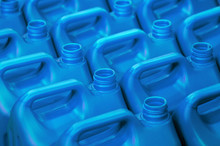 Plastic Canisters Of Light Blue Color In The Warehouse, Production, Factory. Background From Plastic Canisters