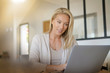 © goodluz - woman telecommuting on her laptop computer at home