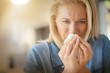 © goodluz - Middle-aged woman with allergy blowing her nose