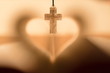 Praying for coronavirus infected men in world, cross and heart symbolizing hope