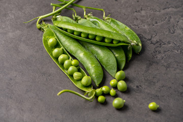 fresh green peas on a dark background