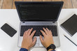 © nikolay100 - Developer coding on a laptop - top view