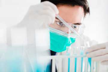 scientist in the laboratory working at lab with test tubes