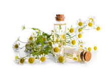 Bottles With Chamomile Essential Oil On White Background