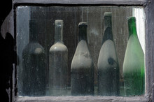 Old, Dusty Bottles Are Standing On The Windowsill