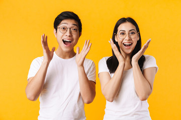 Image of multinational man and woman expressing surprise at camera