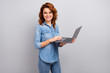 © deagreez - Portrait of positive modern manager woman hold use laptop ready chatting with online clients partners wear good look clothes isolated over grey color background