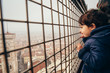© ylenia cancelli - little girl looks through an enclosure at giotto's bell tower and the center of Florence on a foggy day
