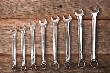 wrenches on wooden background