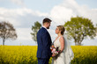 © hreniuca - Beautiful young wedding couple posing outdoor in yellow field