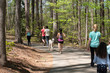 Visitors to Lake Johnson walk and jog along trails while practicing social distancing among the COVID-19 epidemic.