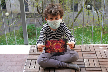 Europe, Italy , Milan - Boy children 5 years old at home with mask during n-cov19 Coronavirus epidemic quarantine at home - desperation for the isolation caused by the closure of schools - life style