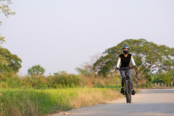 Poster - sporty woman riding a mountain bike in the natural background