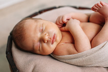 
Newborn Baby Boy, In The Photo The Baby Is 7 Days Old From Birth, Wrapped In A Wrapping, Sleeps Sweetly In A Basket