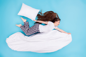 Wall Mural - Full length high angle top above flat lay view photo of funky pretty lady lying flying away ahead hold blanket big pillow having fun wear t-shirt pants pajama isolated blue color background