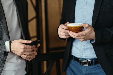 Two businessmen having a chat while standing for a break in a loft space