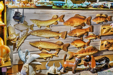 Poster - Wooden fish statues hanging at Riga Christmas market stand Latvia