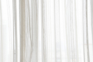 white curtain wavy with a pattern background. transparent curtain on window