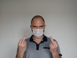 © ALEKSANDR - Man with mask to protect him from Coronavirus. Corona virus pandemic. Young man with mask standing. isolated.