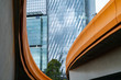 Melbourne Buildings through the curving and converging orange sides of Charles Grimes Bridge across Yarra River.