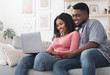 © Prostock-studio - Cheerful Black Couple Using Laptop At Home, Ordering Food Delivery