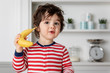 © Lisa Tichané - Cute toddler pretending to phone with a banana