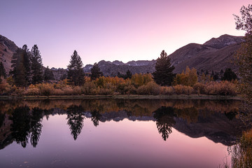 calm evening pink wash over mirrored lake view