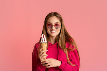 Wall Mural - Girl in round glasses with smeared nose in ice cream