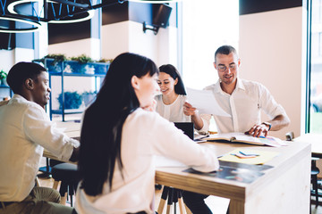 Sticker - Cheerful multiethnic coworkers planning new business strategy