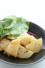 Wall Mural - Potato and anchovy stir fried served with baby leaves