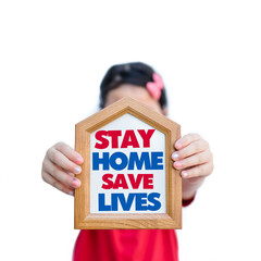 Wall Mural - Stay home save lives.Covid-19 Coronavirus.Stay Learning from home, Social distancing.Happy little asian girl showing home sign.Stay home save lives.Lockdown and Quarantined for control infection.