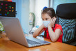 © APchanel - Asian girl with online education. littel girl wear medical mask studying at home, working at laptop notebook with special teacher exercise in coronavirus quarantine.