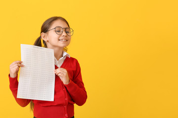 Wall Mural - Pupil with answer sheet for school test on color background