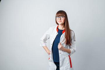 Smiling happy doctor pointing on blue background