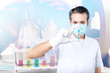 © Leo Lintang - Asian doctor man in flu mask and protective gloves holding a test tube with a coronavirus sample