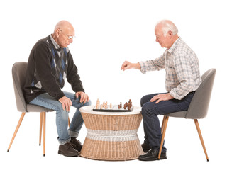 Portrait of elderly men playing chess on white background