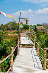 The wooden bridge with rice field at Phrathat San Don temple