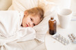 © andrey - kid girl lying on sofa and ill. cure for cold.