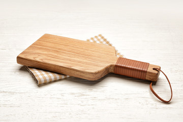 Cutting board on white wooden background