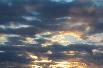Wall Mural - the suns rays pass through the dark clouds. beautiful dramatic sky at sunset or sunrise.
