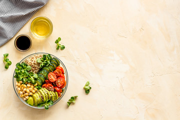 Wall Mural - Vegan bowl. Avocado, quinoa, tomato, spinach and chickpeas vegetables salad on beige table top-down copy space