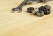 © Vladimir - spanners and nuts on a wooden background.tool with fasteners