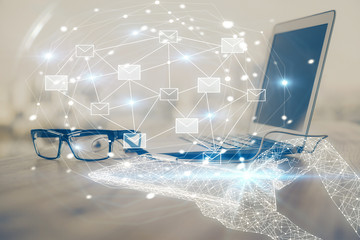 Desktop computer background in office and flying envelops hologram drawing. Multi exposure. Electronic mail concept.