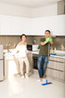 © makistock - Modern kitchen - smiling young Asian woman and man cleaning the floor at home