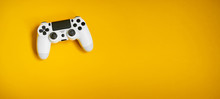 Videgame Competition. Gaming Concept. White Joystick On Yellow Background.