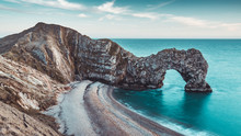 Durdle Door Rocks On Beach Coast In Dorset, England