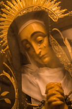 Portugalete, Spain - 10/17/2019: Statue Of Virgin Maria With Tears Through Glass. Sculpture Of Saint Maria With Tears Behind Glass. Sadness And Grief Concept. Sad Madonna Face. Pray And Faith Concept.