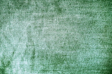 Closeup of jeans fabric with texture and rough surface in dark green tone for grunge background and decoration. Textile texture concept and cool banner on page and cover